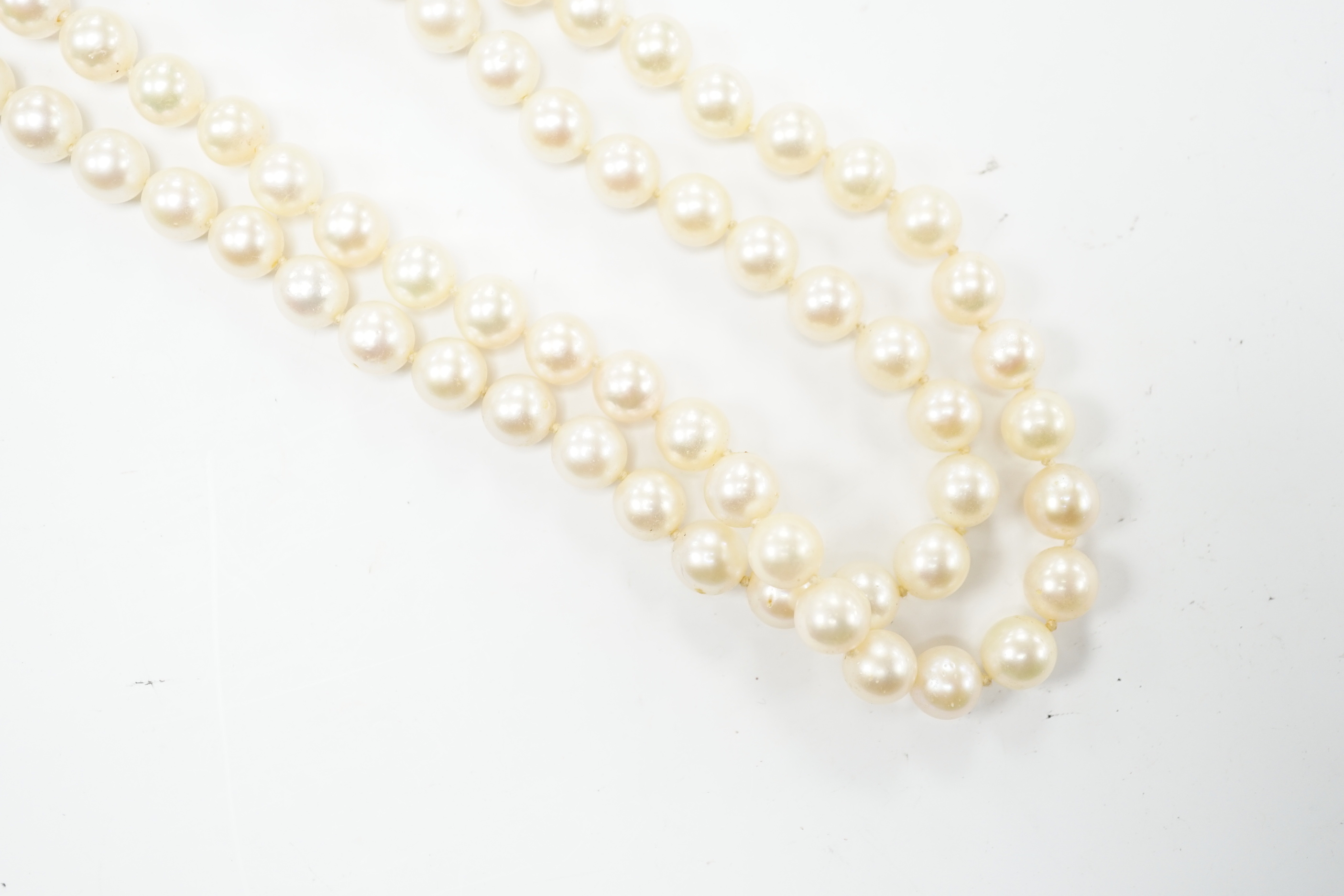 A double strand cultured pearl choker necklace with yellow and white metal, ruby and diamond cluster set clasp, 40cm.